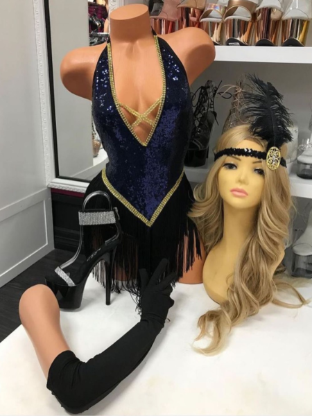 Jazzy Jezebel fringe costume with navy sequin bodysuit, gold crystal trim, black fringe skirt, long gloves, and feather headpiece.