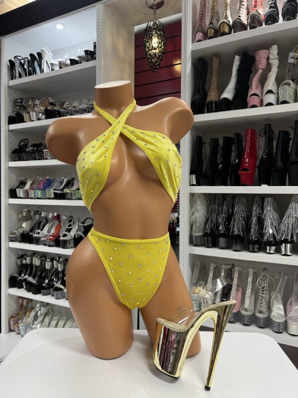 Yellow rhinestone bikini set with halter top and high-cut bottoms on mannequin