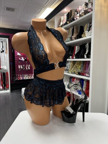 Navy lace halter crop top with sparkling ring detail and matching lace mini skirt displayed on mannequin with black platform heels