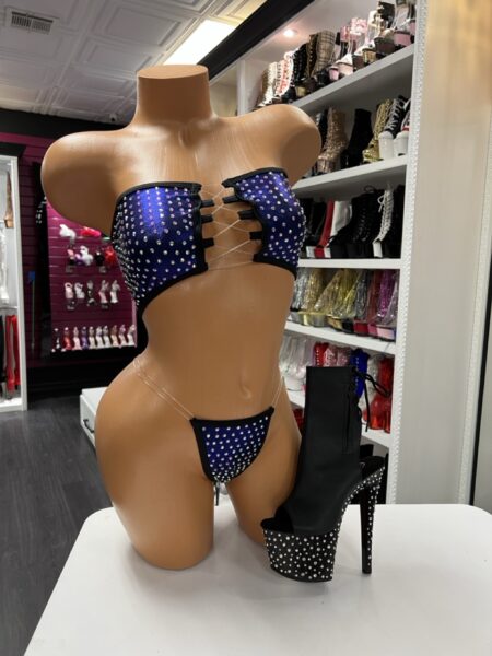 Navy rhinestone cutout two-piece set with bandeau top and micro bottom displayed on mannequin with black rhinestone platform boot