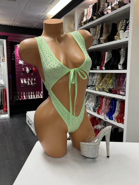 Mint rhinestone cutout bodysuit with lace-up front and high-cut leg displayed on mannequin with rhinestone platform heels
