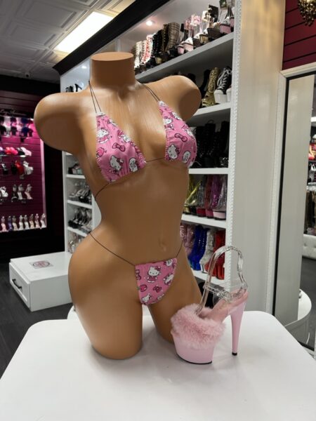 pink cartoon micro bikini set with string ties displayed on mannequin