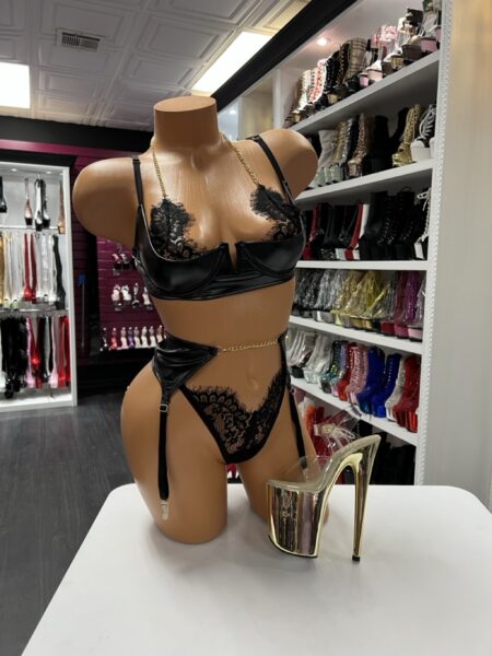black satin and lace lingerie set with garter belt and chain detail on mannequin