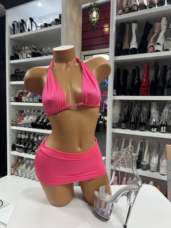 pink skirt set on mannequin with rhinestone bikini top and silver glitter platform heels
