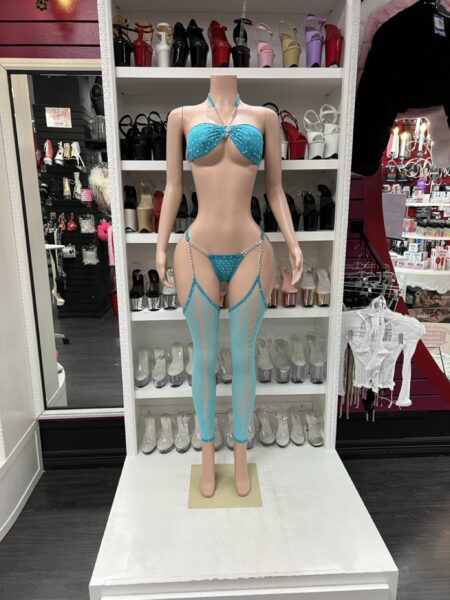 turquoise rhinestone bikini with silver chain straps and turquoise cutout leggings on mannequin