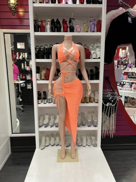 Bright orange two-piece set with lace-up halter top and asymmetrical skirt