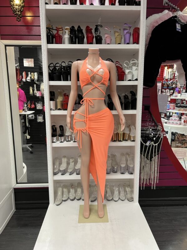 Bright orange two-piece set with lace-up halter top and asymmetrical skirt