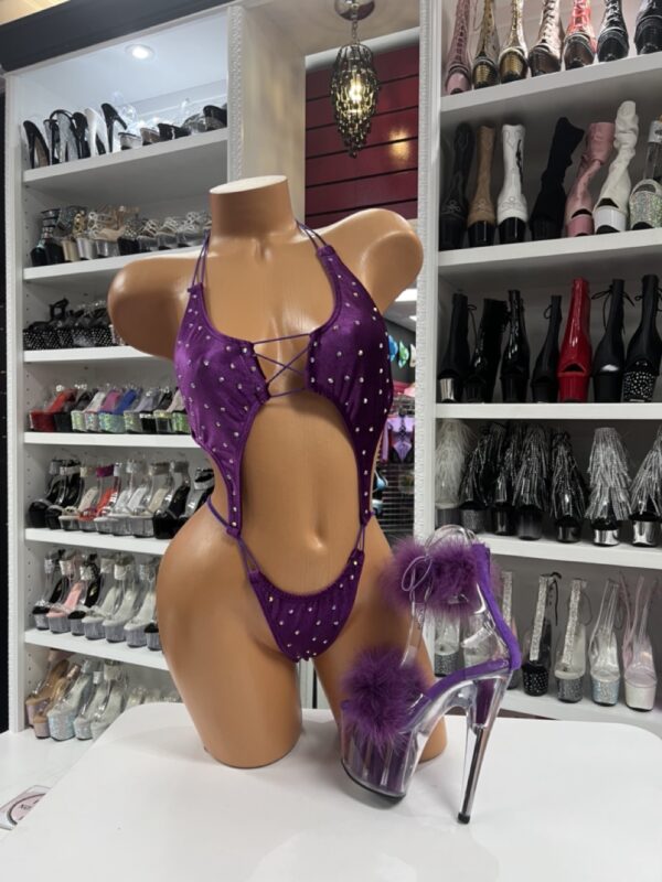 Purple rhinestone bodysuit with cutout details and sparkle embellishments