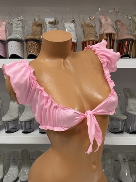 Baby pink tie front crop top with ruffle sleeves on model