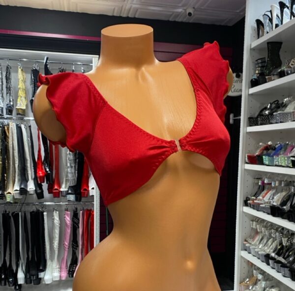 Red Flutter Sleeve Crop Top is your go-to piece when you want a mix of playful flirtation and bold confidence. Designed with a vibrant scarlet hue and ruffled flutter sleeves, this crop top creates an eye-catching silhouette that transitions easily from the stage to a night out. Whether you’re pairing it with a rhinestone skirt, a bikini bottom, or sleek leather pants, this versatile top brings attention where it counts. Designed for Impact The bold red tone is more than just a color—it’s a statement. The flattering cropped cut draws focus to your waistline, while the flutter sleeves add movement and charm. This makes it perfect for performances, festivals, or even casual wear with a daring twist. Comfort Meets Style Crafted from a soft, stretchable material, the top hugs the body without feeling restrictive. The deep neckline creates a dramatic effect while the center ring detail ties the entire look together. You’ll love how this piece blends comfort with allure, keeping you confident in every setting. Why You’ll Love It Bold red shade that instantly grabs attention Flirty flutter sleeves for a feminine edge Cropped design that pairs with skirts, shorts, or dancewear bottoms Stretchy fabric for maximum comfort and mobility Eye-catching ring detail for a polished finish Styling Inspiration Pair the Red Flutter Sleeve Crop Top with our Pink Plunge Dress for a coordinated flirty collection, or mix it with a rhinestone mini skirt for a high-shine stage look. For additional outfit inspiration, check out Cosmopolitan’s fashion trend guide on statement tops that are making waves this season. With its flattering cut and fearless design, the Red Flutter Sleeve Crop Top is more than just clothing—it’s confidence stitched into fabric.