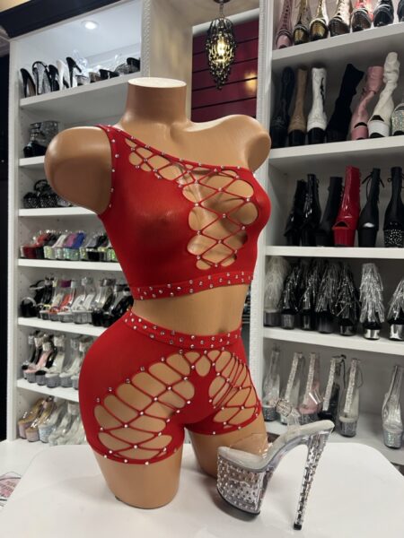 Red rhinestone cutout outfit with one-shoulder top and shorts on mannequin