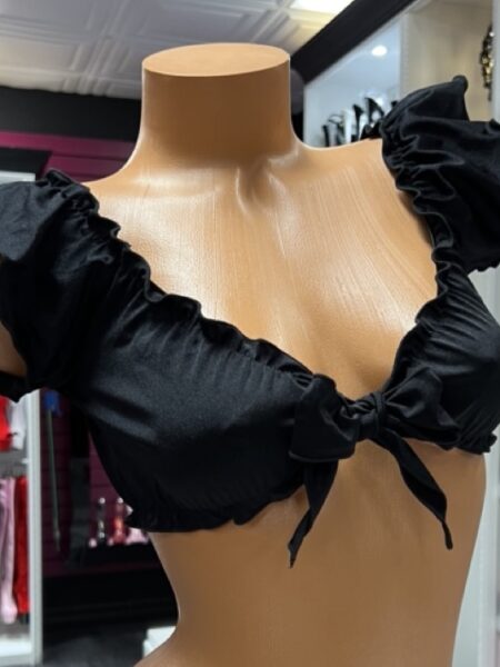 Chic black ruffle tie front crop top on mannequin display