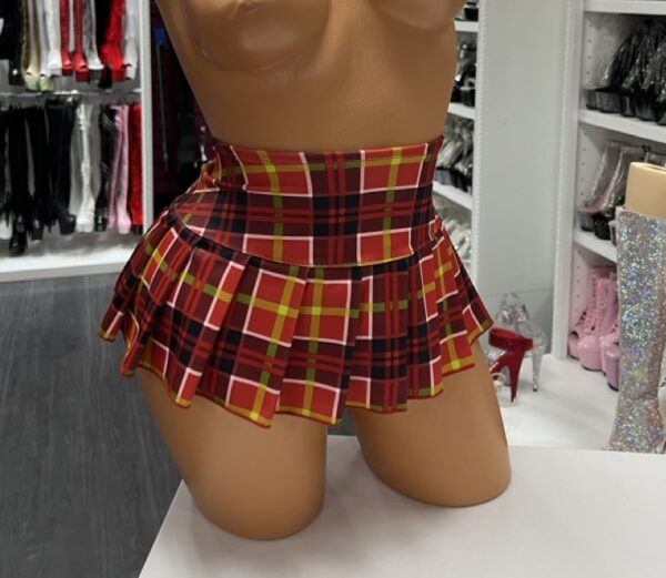 Red plaid schoolgirl mini skirt with pleated design on model