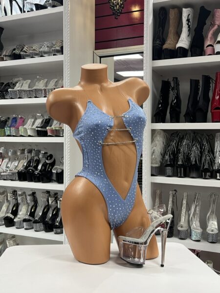 Light blue rhinestone cutout bodysuit with halter neckline and thong back displayed on mannequin with clear platform heels