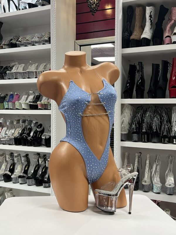 Light blue rhinestone cutout bodysuit with halter neckline and thong back displayed on mannequin with clear platform heels