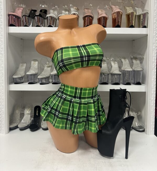 Mannequin wearing green plaid micro skirt two-piece with bandeau top and pleated skirt for stagewear and clubwear