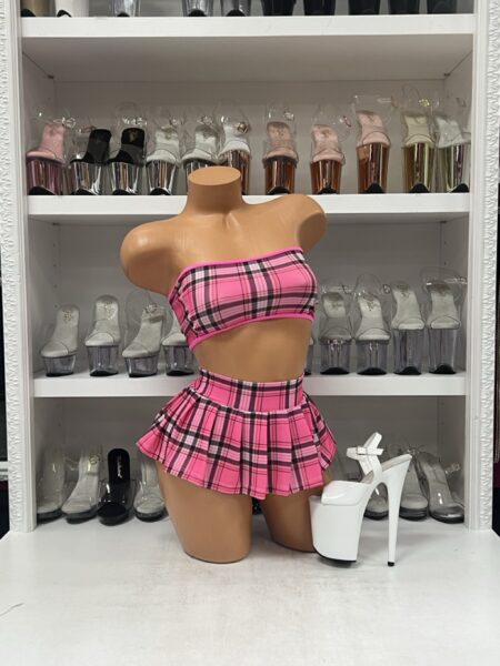 Mannequin wearing pink plaid micro skirt two-piece with bandeau top and pleated skirt for stagewear and nightlife fashion