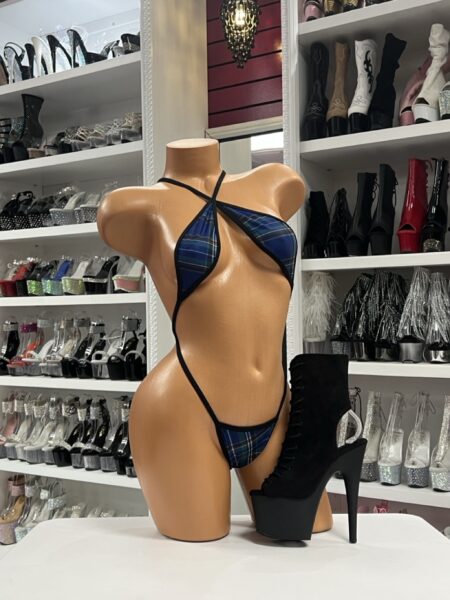 Mannequin wearing plaid slingshot micro bikini with halter neckline and revealing cut for stagewear and clubwear