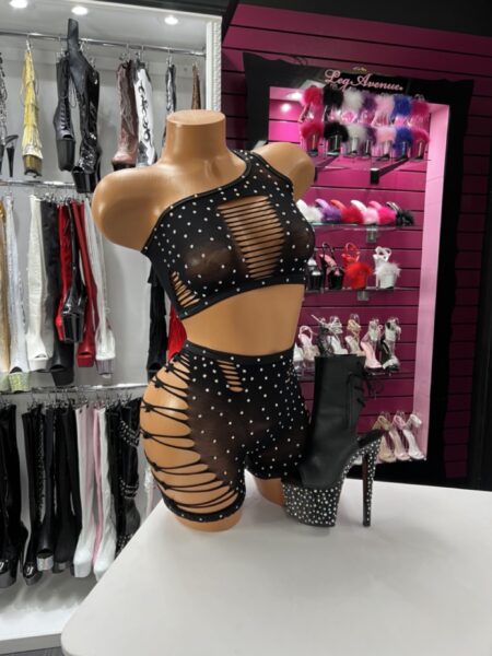 Woman wearing stretchy black fishnet short set with high-waist shorts and cropped top