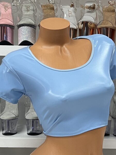 Baby blue vinyl crop top with short sleeves and scoop neck on model