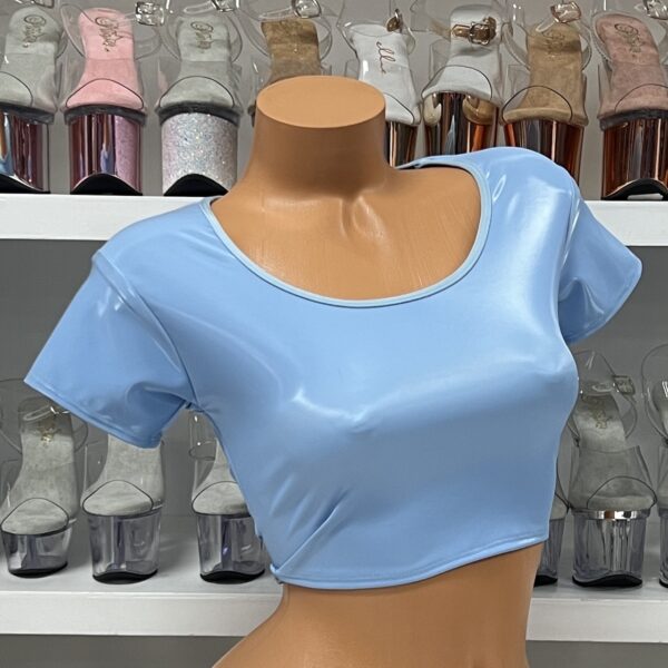 Baby blue vinyl crop top with short sleeves and scoop neck on model