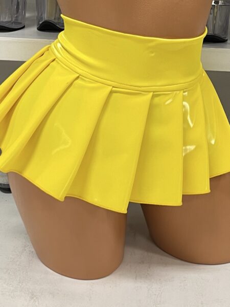 Bright yellow vinyl pleated mini skirt on mannequin display