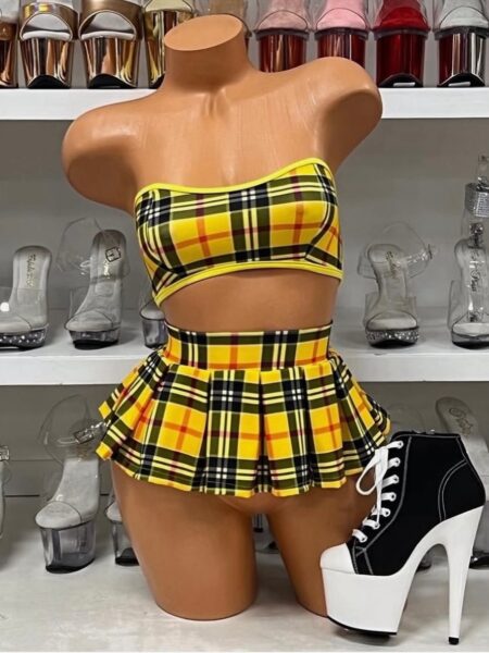Yellow Plaid Skirt Set brings playful school-girl vibes with a bold, flirty twist. This two-piece outfit features a strapless plaid crop top paired with a pleated mini skirt that instantly makes a statement. Whether you’re heading to a themed party, creating a show-stopping stage look, or spicing up your dancewear collection, this plaid set gives you all the confidence to turn heads. The strapless crop top offers a secure yet comfortable fit, while the pleated mini skirt moves effortlessly with your body. Designed with performance and style in mind, this plaid skirt set makes every step, twirl, and pose unforgettable. The yellow-and-black plaid print keeps the look eye-catching, fun, and instantly recognizable as a daring fashion choice. Pair this Yellow Plaid Skirt Set with platform boots, sneakers, or heels for versatile styling. Add bold accessories, such as thigh-high socks or chokers, to enhance the playful energy of the outfit. Whether on stage, at an event, or in your personal collection, this set gives you a fashion-forward edge. Why You’ll Love It Two-piece design: Bandeau crop top + pleated plaid mini skirt. Bold plaid pattern: Yellow and black plaid with red accents for instant impact. Playful school-girl aesthetic: A fresh, confident twist on a classic style. Versatile wear: Perfect for performances, themed events, or styled as statement fashion. Comfortable fit: Stretchy fabric that hugs the body without limiting movement. Styling Ideas This set can be styled in countless ways. Pair it with a pair of black thigh-high stockings and lace-up platform boots for a daring club-ready look, or keep it simple with heels for a flirty, polished vibe. For even more ideas, check out our school-girl inspired outfits collection at PZ Houston. Quality & Care The lightweight yet durable material ensures you’ll get plenty of wear without losing shape or comfort. Hand wash cold and air dry to keep the plaid print bright and bold for every occasion. With its bold colors, playful pleats, and confident energy, this Yellow Plaid Skirt Set is more than just an outfit—it’s an attitude.