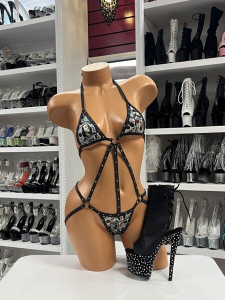 Black money print romper with rhinestone trim and strappy harness front view