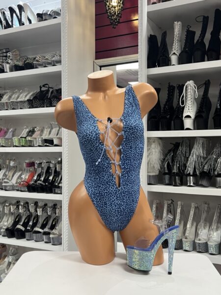 Blue leopard print romper with plunging lace-up front detail on mannequin