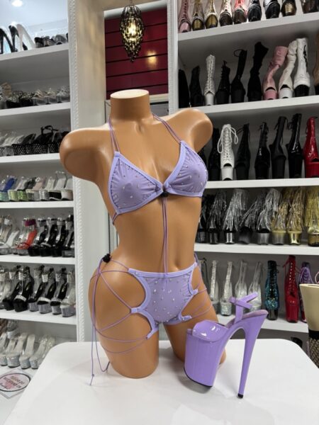 Lilac rhinestone bikini top and shorts set with lace-up side cutouts on mannequin