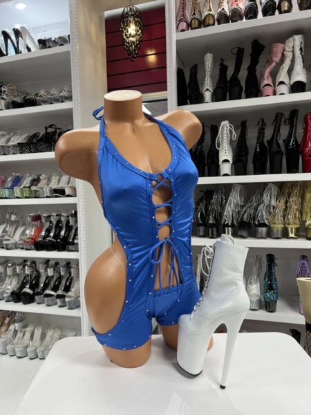 Royal blue halter romper with front lace-up cutout detail on mannequin