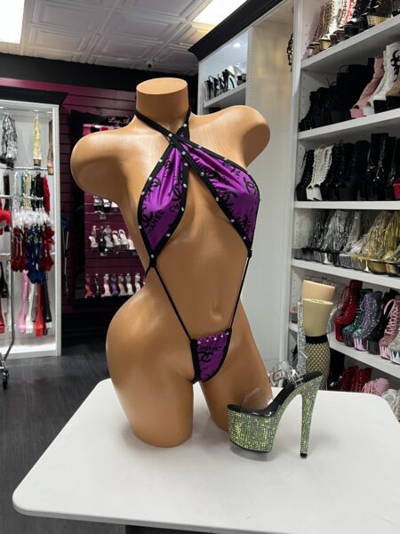 Purple logo slingshot bodysuit with rhinestone trim and black straps
