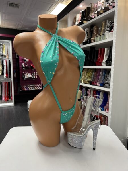 Teal slingshot-style performance suit with rhinestone detailing and halter neckline