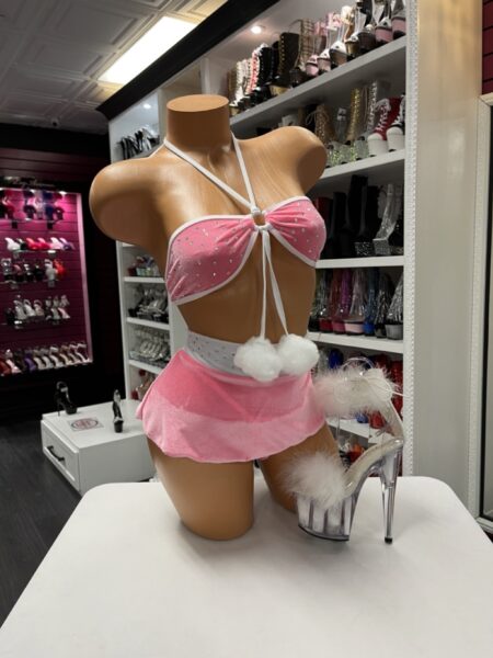 “Pink velvet rhinestone top with matching mini skirt and pom-poms”
