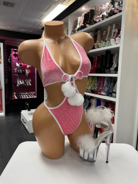 “Pink velvet rhinestone monokini with white trim and pom-poms”