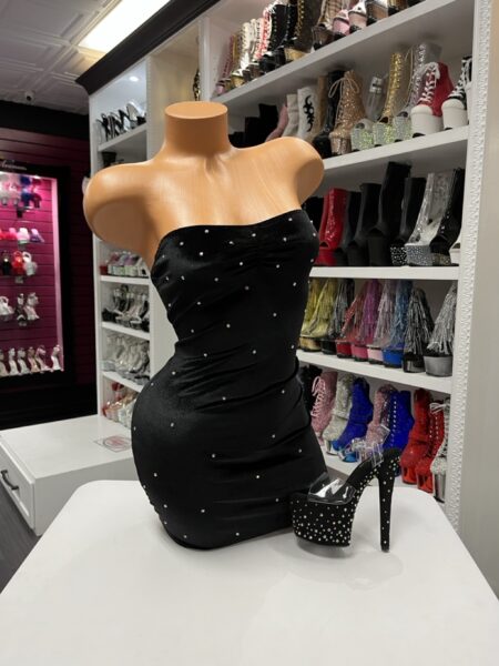 Black strapless rhinestone mini dress on mannequin with black studded platform heels
