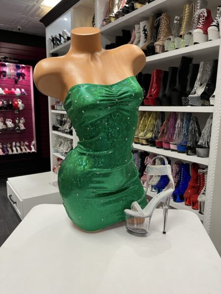 Green strapless rhinestone mini dress on mannequin with clear platform heels