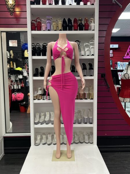 Fuchsia cutout skirt set with halter crop top and high slit skirt on mannequin