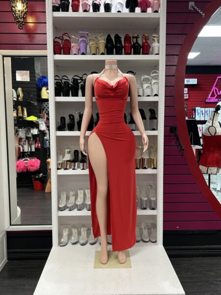 Red rhinestone slit dress with halter neckline and high side slit on mannequin