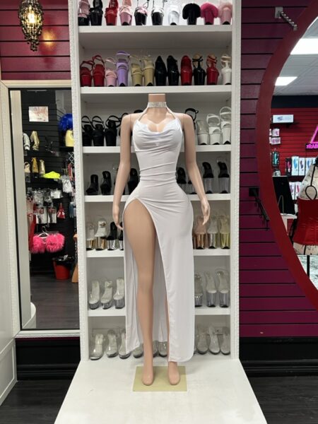 White rhinestone slit dress with halter neckline and high side slit on mannequin