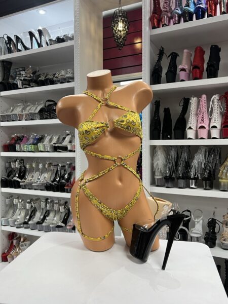 Model wearing yellow bandana harness set with adjustable straps and metallic ring accents