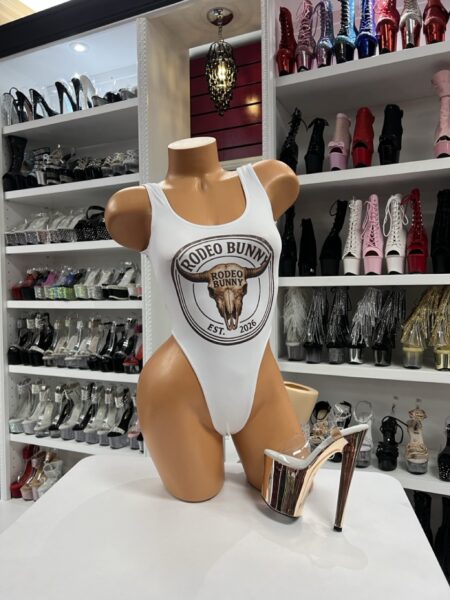 Western graphic highcut bodysuit with bold front design displayed on mannequin in boutique showroom