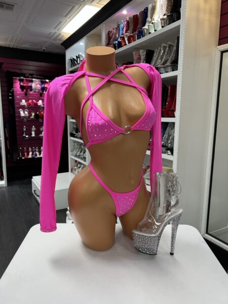 Neon pink crystal strap performance set with long sleeves and multi-strap design displayed on mannequin