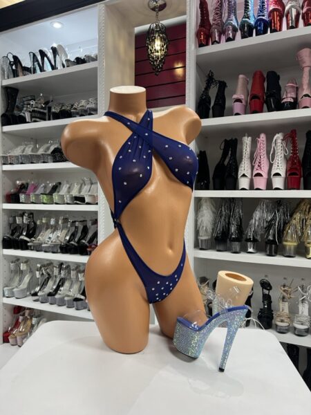 Navy rhinestone slingshot bodysuit on mannequin in dancewear store