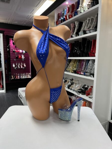 Blue rhinestone slingshot bodysuit with halter neckline and ultra minimal cut on mannequin