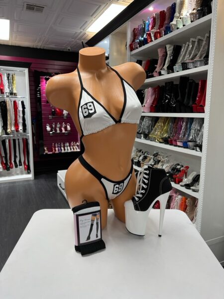 Sporty black and white varsity style bikini set with halter top displayed on mannequin