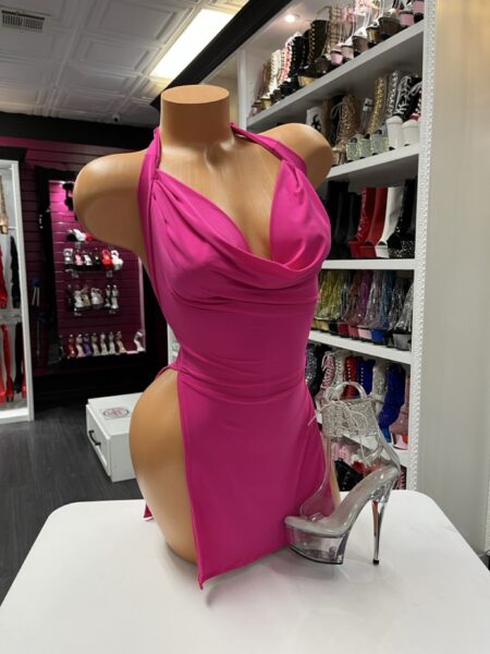 Hot pink halter mini dress with draped neckline and fitted silhouette displayed on mannequin