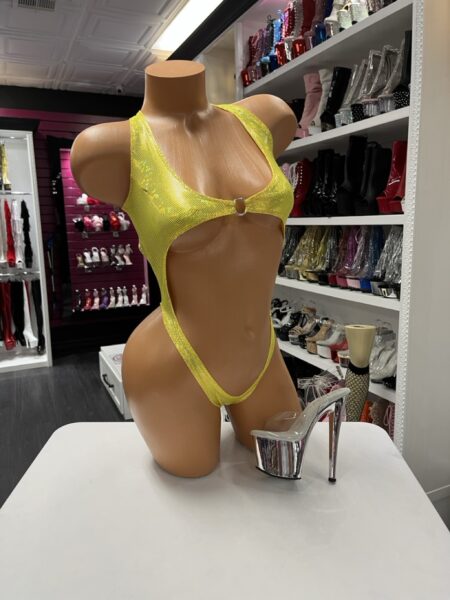 Holographic yellow mesh cutout bodysuit displayed on mannequin for stage wear