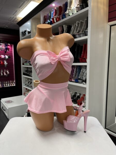 Pink bow skirt set with strapless bandeau top and flared mini skirt on mannequin
