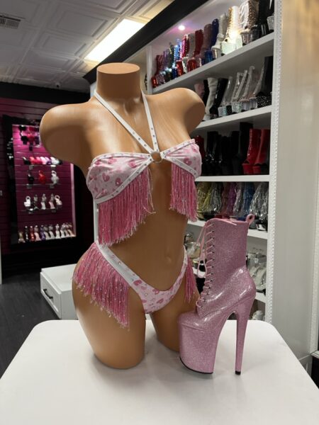 Pink heart print fringe three piece performance set displayed on mannequin